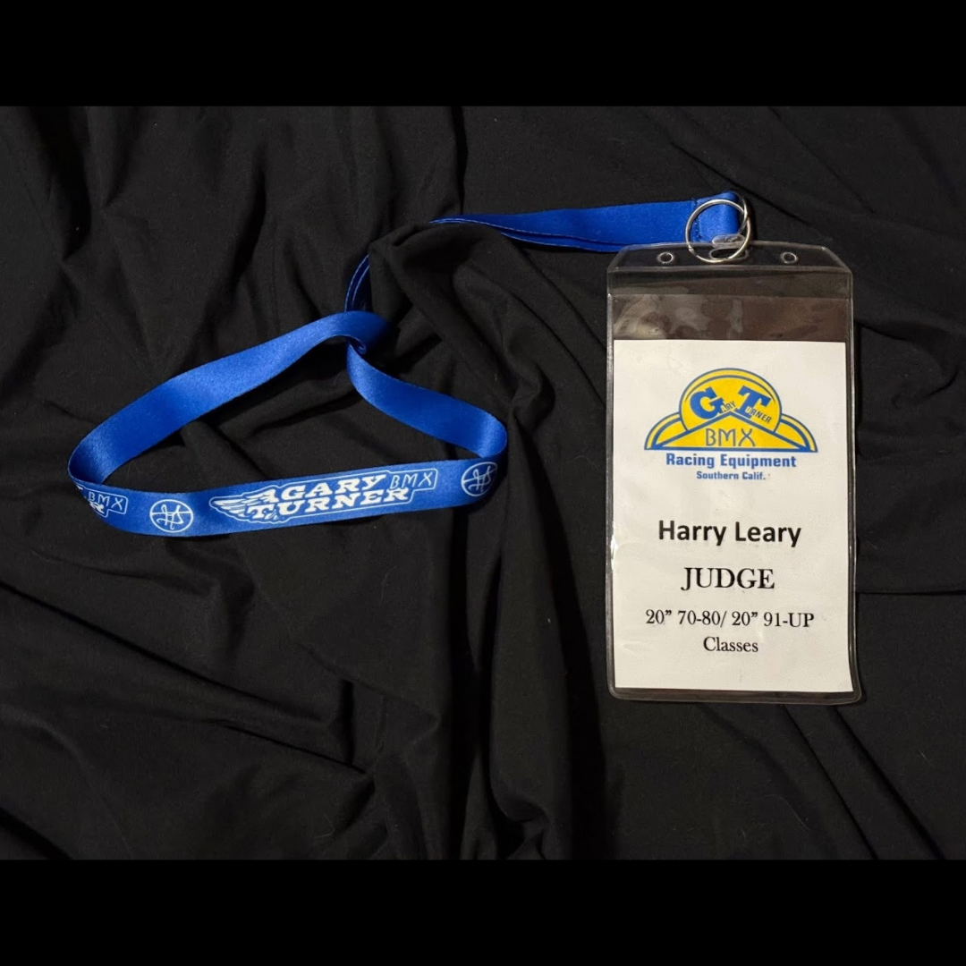 Blue Gary Turner BMX lanyard with a credential reading Harry Leary, Judge, for 20-inch age-group classes.