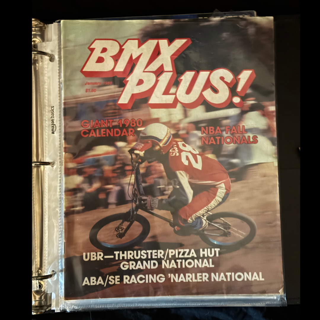 January 1980 issue of BMX Plus! preserved in a binder, with a BMX racer on the cover.