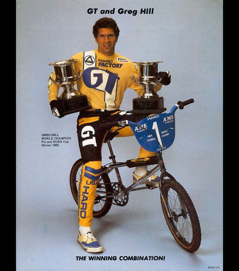 Greg Hill posing with a GT BMX bike and two trophy cups in a vintage NORA Cup promotional image