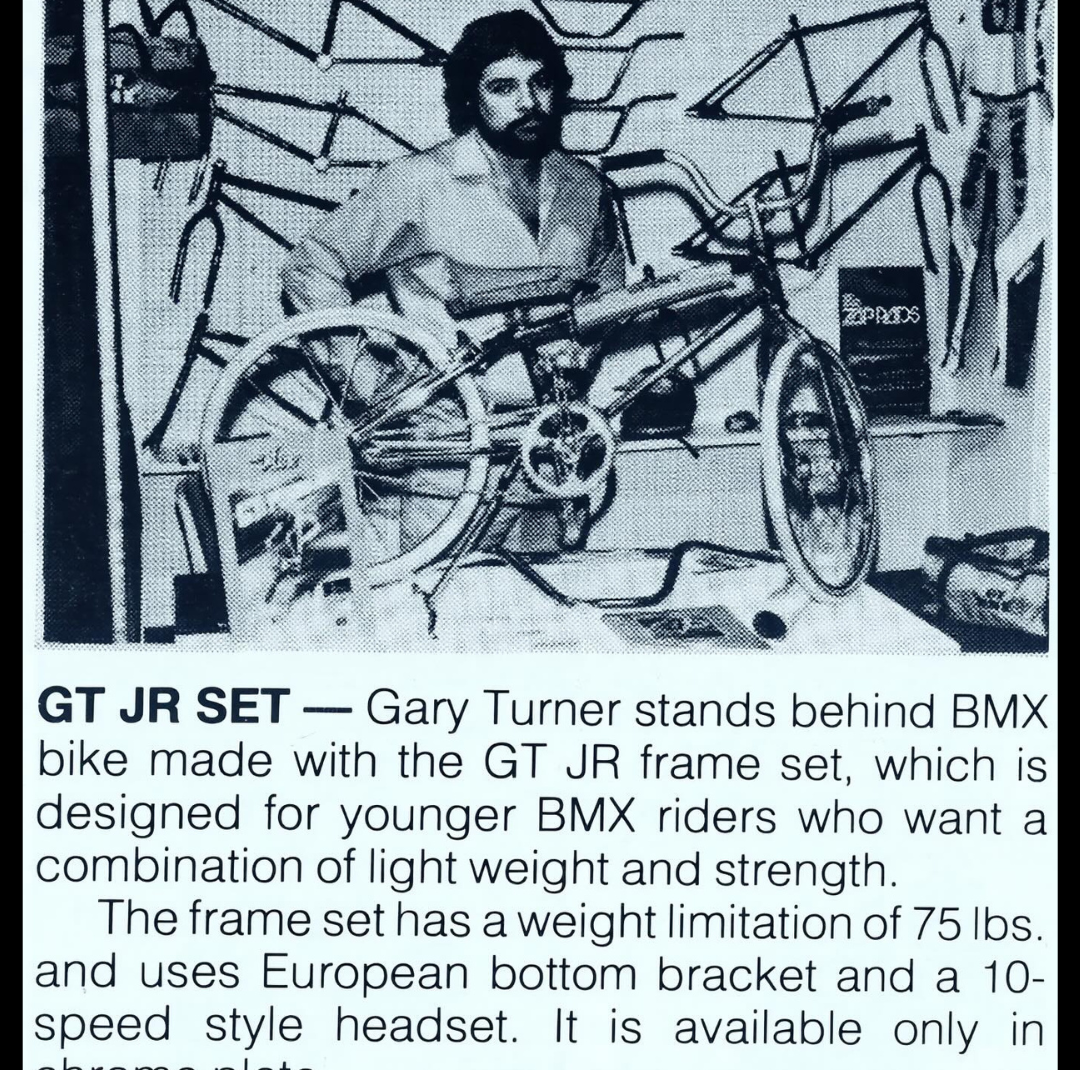 Vintage GT JR frame-set feature showing Gary Turner behind a BMX bicycle in a workshop filled with frames